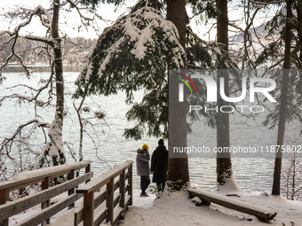 Hikers are at Eibsee in Grainau, Bavaria, Germany, on December 13, 2024. The lake is located 9 km southwest of Garmisch-Partenkirchen below...