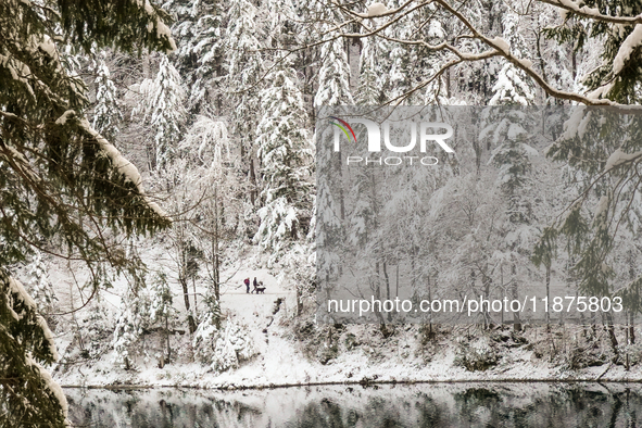 Hikers are at Eibsee in Grainau, Bavaria, Germany, on December 13, 2024. The lake is located 9 km southwest of Garmisch-Partenkirchen below...