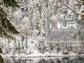 Hikers are at Eibsee in Grainau, Bavaria, Germany, on December 13, 2024. The lake is located 9 km southwest of Garmisch-Partenkirchen below...