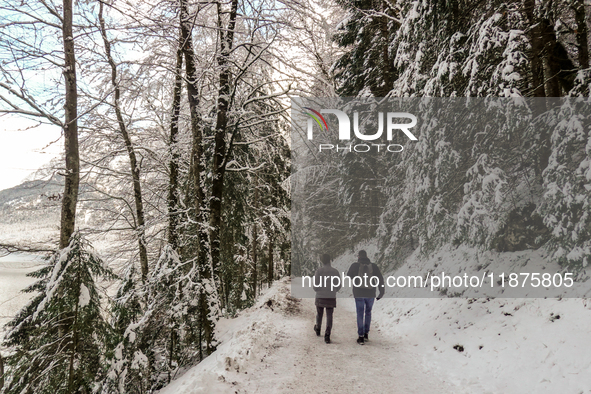 Hikers are at Eibsee in Grainau, Bavaria, Germany, on December 13, 2024. The lake is located 9 km southwest of Garmisch-Partenkirchen below...