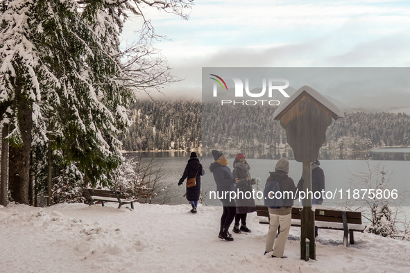 Hikers are at Eibsee in Grainau, Bavaria, Germany, on December 13, 2024. The lake is located 9 km southwest of Garmisch-Partenkirchen below...