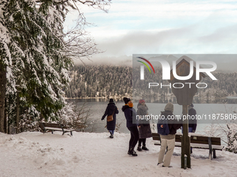 Hikers are at Eibsee in Grainau, Bavaria, Germany, on December 13, 2024. The lake is located 9 km southwest of Garmisch-Partenkirchen below...