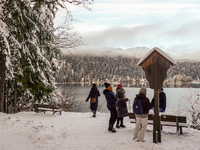 Hikers are at Eibsee in Grainau, Bavaria, Germany, on December 13, 2024. The lake is located 9 km southwest of Garmisch-Partenkirchen below...