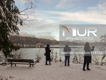 Hikers are at Eibsee in Grainau, Bavaria, Germany, on December 13, 2024. The lake is located 9 km southwest of Garmisch-Partenkirchen below...