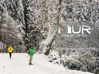 Hikers are at Eibsee in Grainau, Bavaria, Germany, on December 13, 2024. The lake is located 9 km southwest of Garmisch-Partenkirchen below...