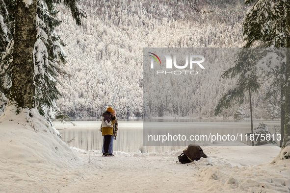 Hikers are at Eibsee in Grainau, Bavaria, Germany, on December 13, 2024. The lake is located 9 km southwest of Garmisch-Partenkirchen below...