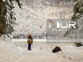 Hikers are at Eibsee in Grainau, Bavaria, Germany, on December 13, 2024. The lake is located 9 km southwest of Garmisch-Partenkirchen below...