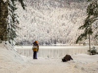 Hikers are at Eibsee in Grainau, Bavaria, Germany, on December 13, 2024. The lake is located 9 km southwest of Garmisch-Partenkirchen below...