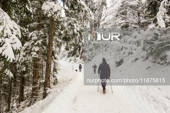 Hikers are at Eibsee in Grainau, Bavaria, Germany, on December 13, 2024. The lake is located 9 km southwest of Garmisch-Partenkirchen below...