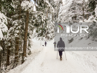 Hikers are at Eibsee in Grainau, Bavaria, Germany, on December 13, 2024. The lake is located 9 km southwest of Garmisch-Partenkirchen below...