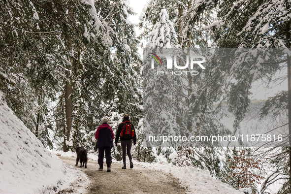 Hikers are at Eibsee in Grainau, Bavaria, Germany, on December 13, 2024. The lake is located 9 km southwest of Garmisch-Partenkirchen below...