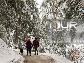 Hikers are at Eibsee in Grainau, Bavaria, Germany, on December 13, 2024. The lake is located 9 km southwest of Garmisch-Partenkirchen below...