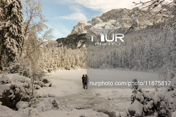 Hikers are at Eibsee in Grainau, Bavaria, Germany, on December 13, 2024. The lake is located 9 km southwest of Garmisch-Partenkirchen below...