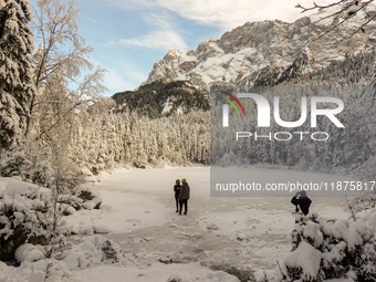 Hikers are at Eibsee in Grainau, Bavaria, Germany, on December 13, 2024. The lake is located 9 km southwest of Garmisch-Partenkirchen below...