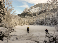 Hikers are at Eibsee in Grainau, Bavaria, Germany, on December 13, 2024. The lake is located 9 km southwest of Garmisch-Partenkirchen below...