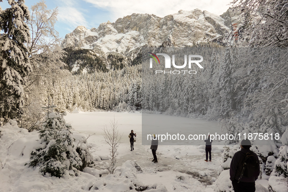 Hikers are at Eibsee in Grainau, Bavaria, Germany, on December 13, 2024. The lake is located 9 km southwest of Garmisch-Partenkirchen below...