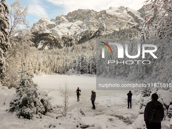 Hikers are at Eibsee in Grainau, Bavaria, Germany, on December 13, 2024. The lake is located 9 km southwest of Garmisch-Partenkirchen below...