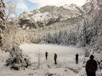 Hikers are at Eibsee in Grainau, Bavaria, Germany, on December 13, 2024. The lake is located 9 km southwest of Garmisch-Partenkirchen below...