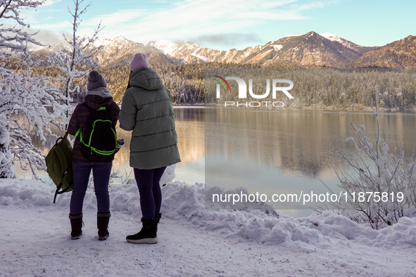 Hikers are at Eibsee in Grainau, Bavaria, Germany, on December 13, 2024. The lake is located 9 km southwest of Garmisch-Partenkirchen below...