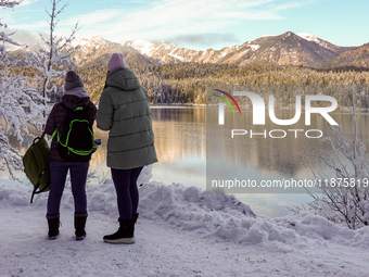 Hikers are at Eibsee in Grainau, Bavaria, Germany, on December 13, 2024. The lake is located 9 km southwest of Garmisch-Partenkirchen below...