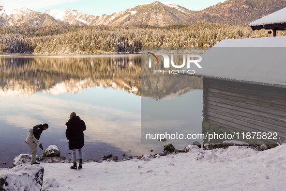 Hikers are at Eibsee in Grainau, Bavaria, Germany, on December 13, 2024. The lake is located 9 km southwest of Garmisch-Partenkirchen below...