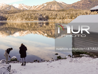 Hikers are at Eibsee in Grainau, Bavaria, Germany, on December 13, 2024. The lake is located 9 km southwest of Garmisch-Partenkirchen below...