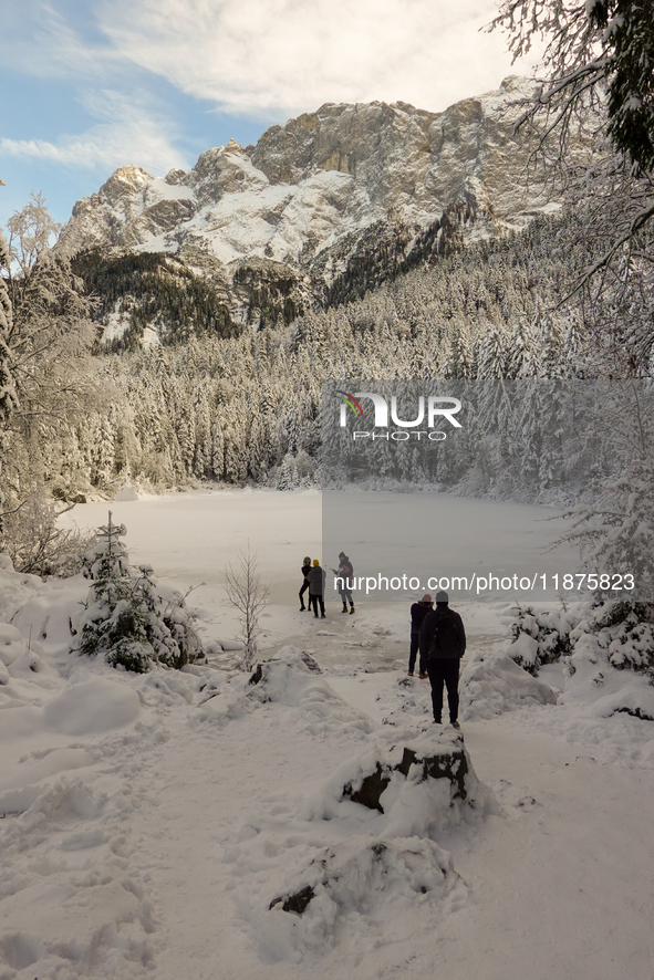 Hikers are at Eibsee in Grainau, Bavaria, Germany, on December 13, 2024. The lake is located 9 km southwest of Garmisch-Partenkirchen below...