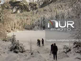 Hikers are at Eibsee in Grainau, Bavaria, Germany, on December 13, 2024. The lake is located 9 km southwest of Garmisch-Partenkirchen below...