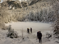 Hikers are at Eibsee in Grainau, Bavaria, Germany, on December 13, 2024. The lake is located 9 km southwest of Garmisch-Partenkirchen below...