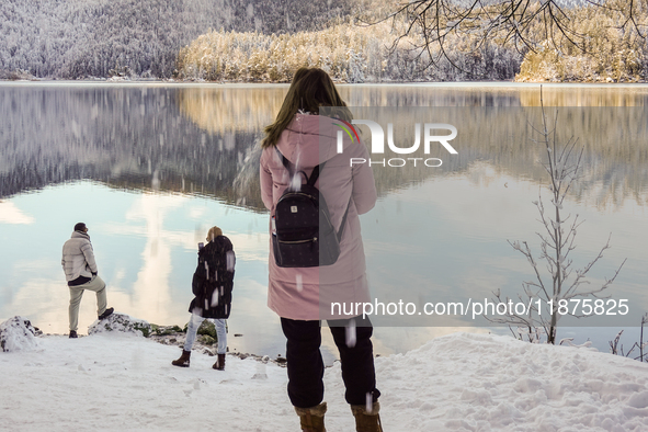 Hikers are at Eibsee in Grainau, Bavaria, Germany, on December 13, 2024. The lake is located 9 km southwest of Garmisch-Partenkirchen below...