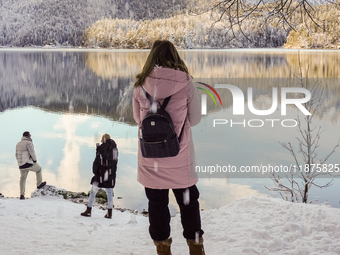 Hikers are at Eibsee in Grainau, Bavaria, Germany, on December 13, 2024. The lake is located 9 km southwest of Garmisch-Partenkirchen below...