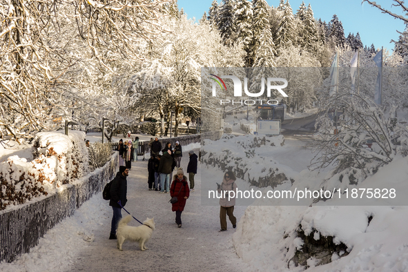 Hikers are at Eibsee in Grainau, Bavaria, Germany, on December 13, 2024. The lake is located 9 km southwest of Garmisch-Partenkirchen below...