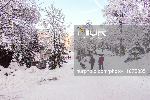 Hikers are at Eibsee in Grainau, Bavaria, Germany, on December 13, 2024. The lake is located 9 km southwest of Garmisch-Partenkirchen below...