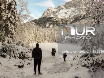 Hikers are at Eibsee in Grainau, Bavaria, Germany, on December 13, 2024. The lake is located 9 km southwest of Garmisch-Partenkirchen below...