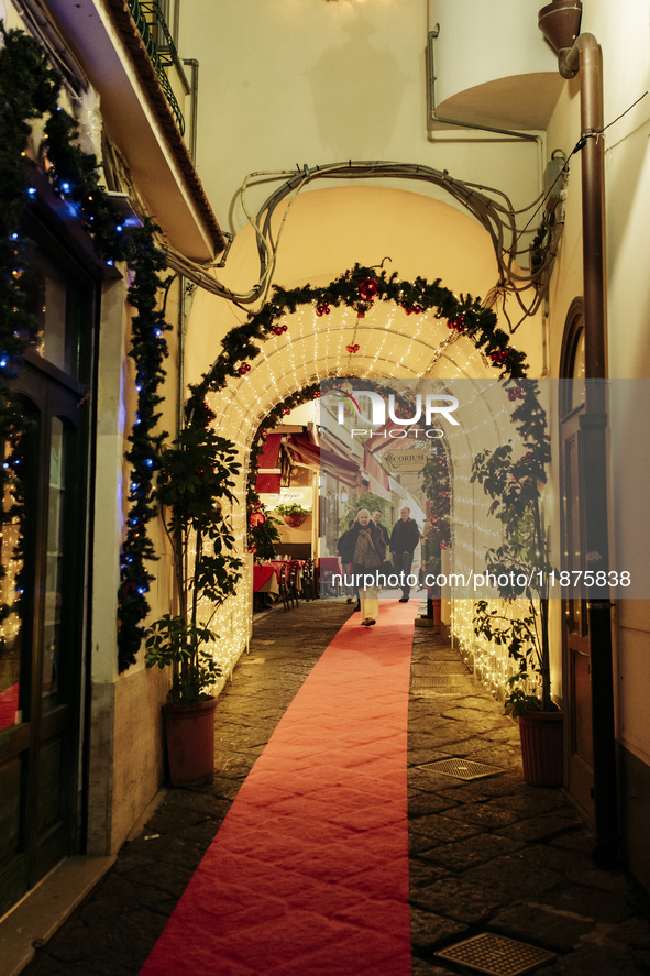 Christmas lights adorn a small alley in Sorrento, Naples, Italy, on December 16, 2024. Sorrento is a town overlooking the Bays of Naples in...