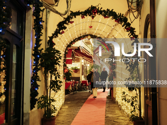 Christmas lights adorn a small alley in Sorrento, Naples, Italy, on December 16, 2024. Sorrento is a town overlooking the Bays of Naples in...