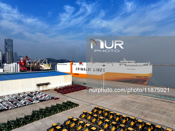 A ro-ro ship loads export vehicles at a port in Lianyungang, China, on December 18, 2024. 