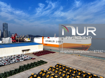 A ro-ro ship loads export vehicles at a port in Lianyungang, China, on December 18, 2024. (