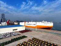 A ro-ro ship loads export vehicles at a port in Lianyungang, China, on December 18, 2024. (