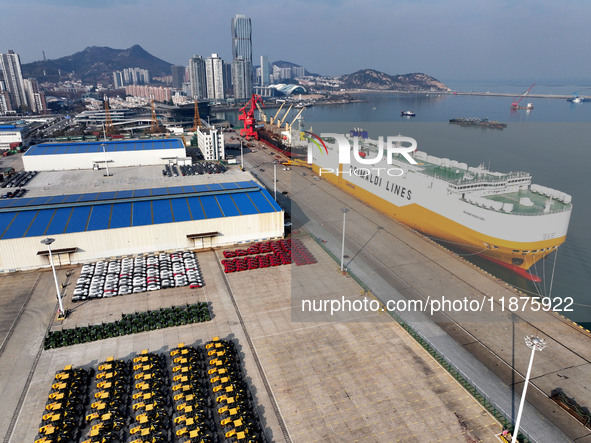 A ro-ro ship loads export vehicles at a port in Lianyungang, China, on December 18, 2024. 