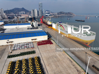 A ro-ro ship loads export vehicles at a port in Lianyungang, China, on December 18, 2024. (