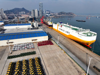 A ro-ro ship loads export vehicles at a port in Lianyungang, China, on December 18, 2024. (