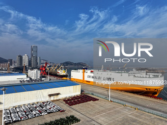 A ro-ro ship loads export vehicles at a port in Lianyungang, China, on December 18, 2024. (