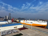 A ro-ro ship loads export vehicles at a port in Lianyungang, China, on December 18, 2024. (