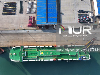 A ro-ro ship loads export vehicles at a port in Lianyungang, China, on December 18, 2024. (