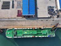 A ro-ro ship loads export vehicles at a port in Lianyungang, China, on December 18, 2024. (