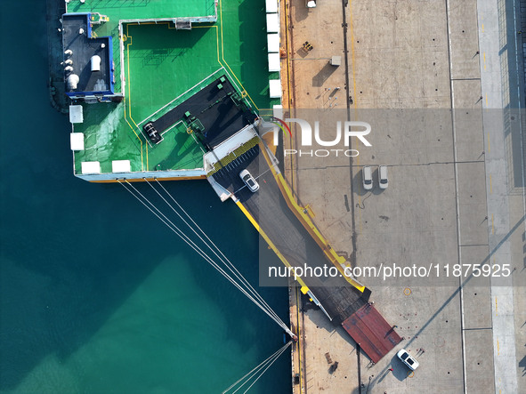 A ro-ro ship loads export vehicles at a port in Lianyungang, China, on December 18, 2024. 