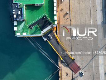 A ro-ro ship loads export vehicles at a port in Lianyungang, China, on December 18, 2024. (