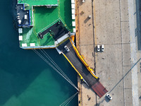 A ro-ro ship loads export vehicles at a port in Lianyungang, China, on December 18, 2024. (