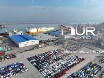 A ro-ro ship loads export vehicles at a port in Lianyungang, China, on December 18, 2024. (